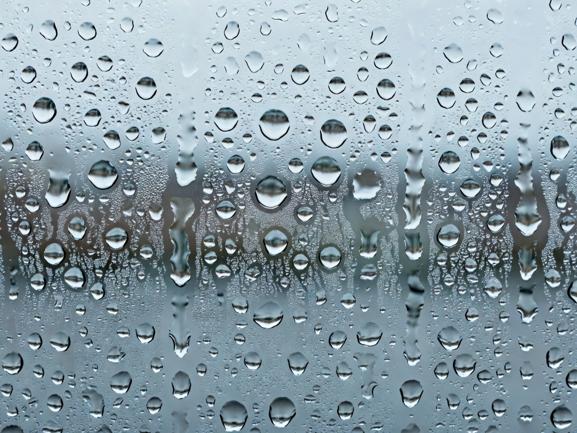 Macro photography of water condensation droplets covering a window pane